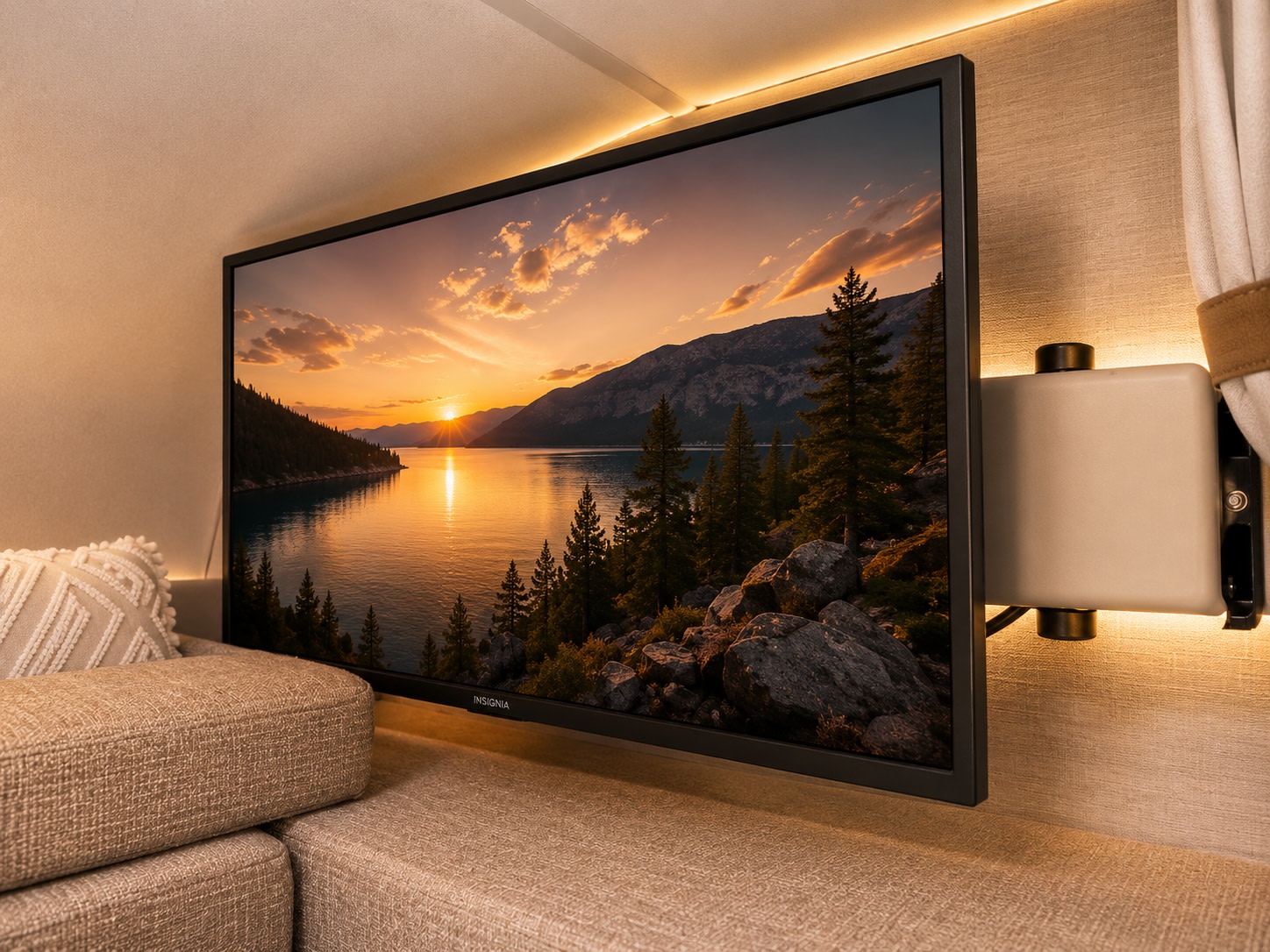 Cozy RV rental interior with a mounted TV displaying a stunning sunset lake view, perfect for relaxing after exploring.. Thor Coleman 2025