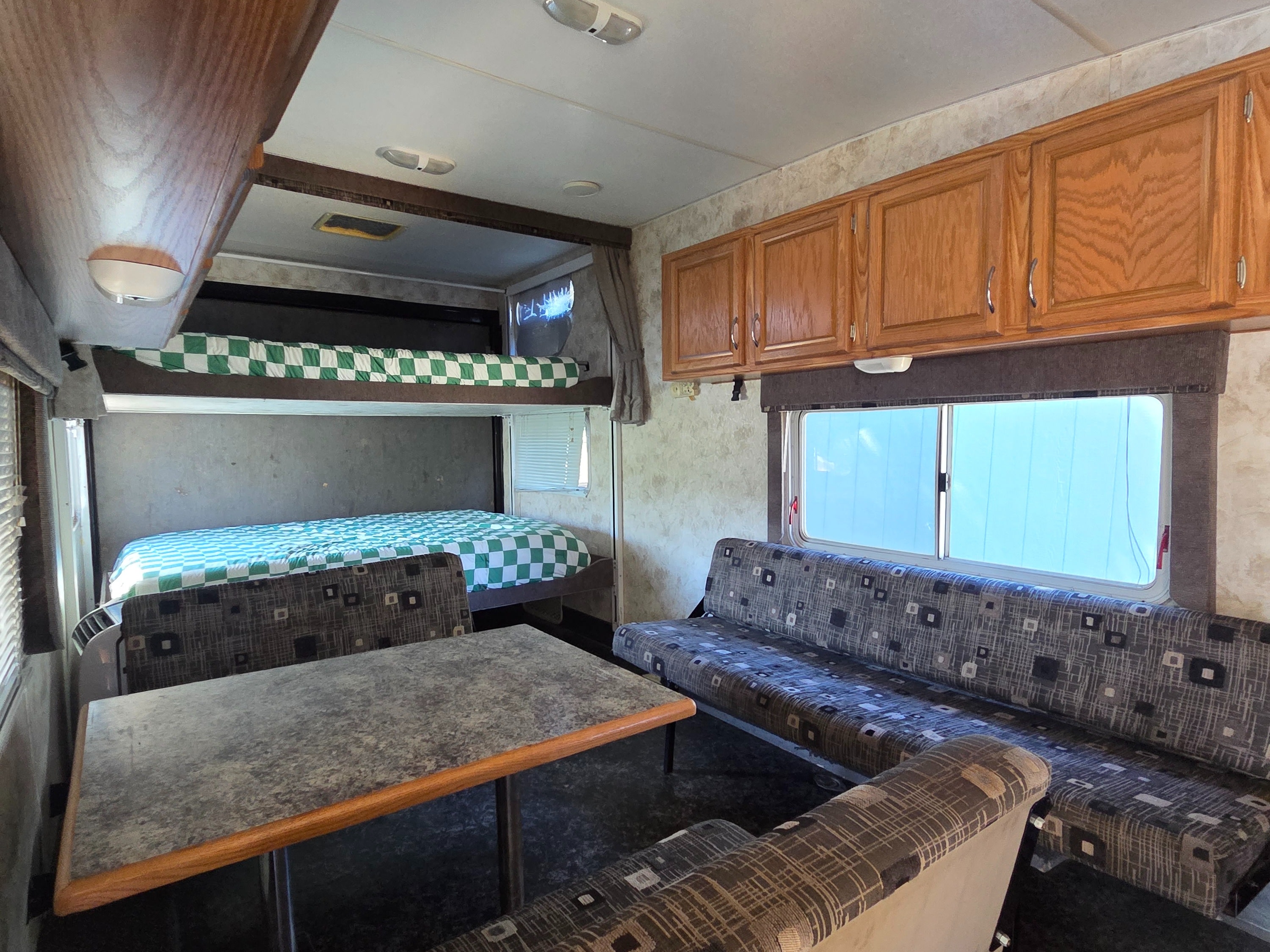 Inside this RV rental: bunk beds, a dinette, and wood cabinets offer a functional travel space.. Eclipse Recreational Vehicles Attitude 2006