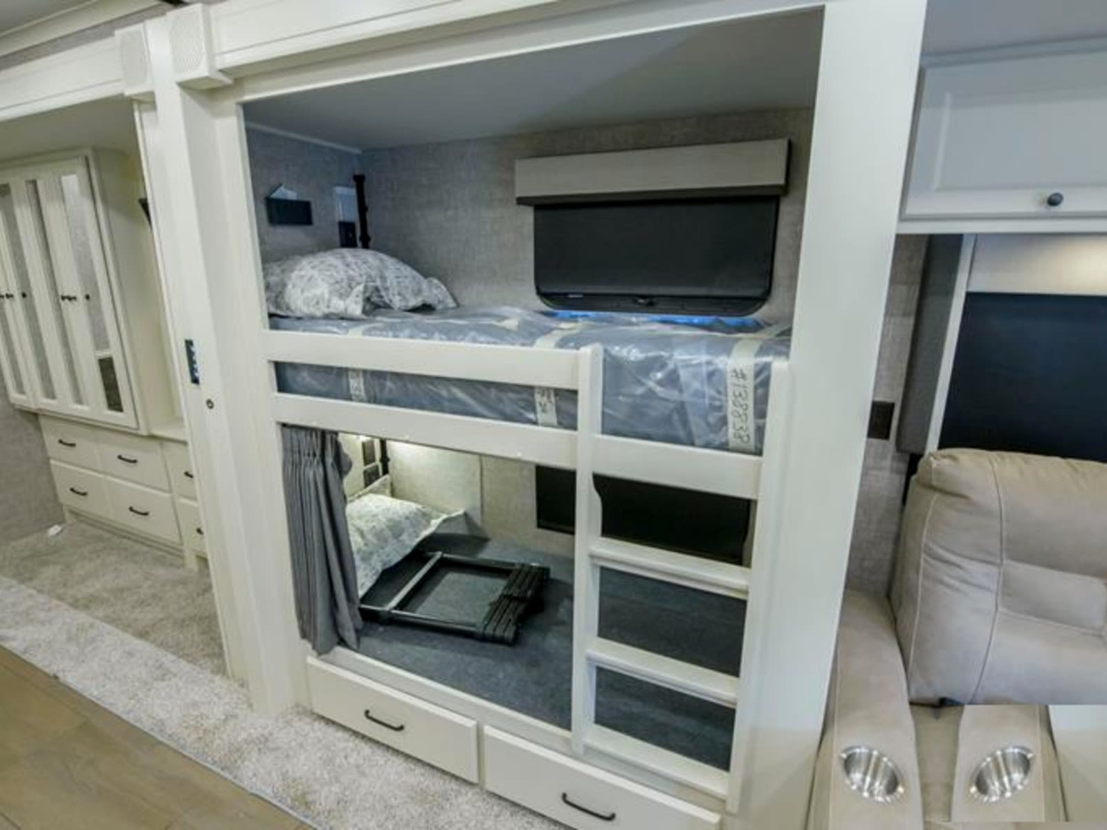 Cozy RV rental interior with built-in bunk beds, a wardrobe, and plush seating. Ideal for family adventures on the road.. Allegro Allegro Open Road 2025