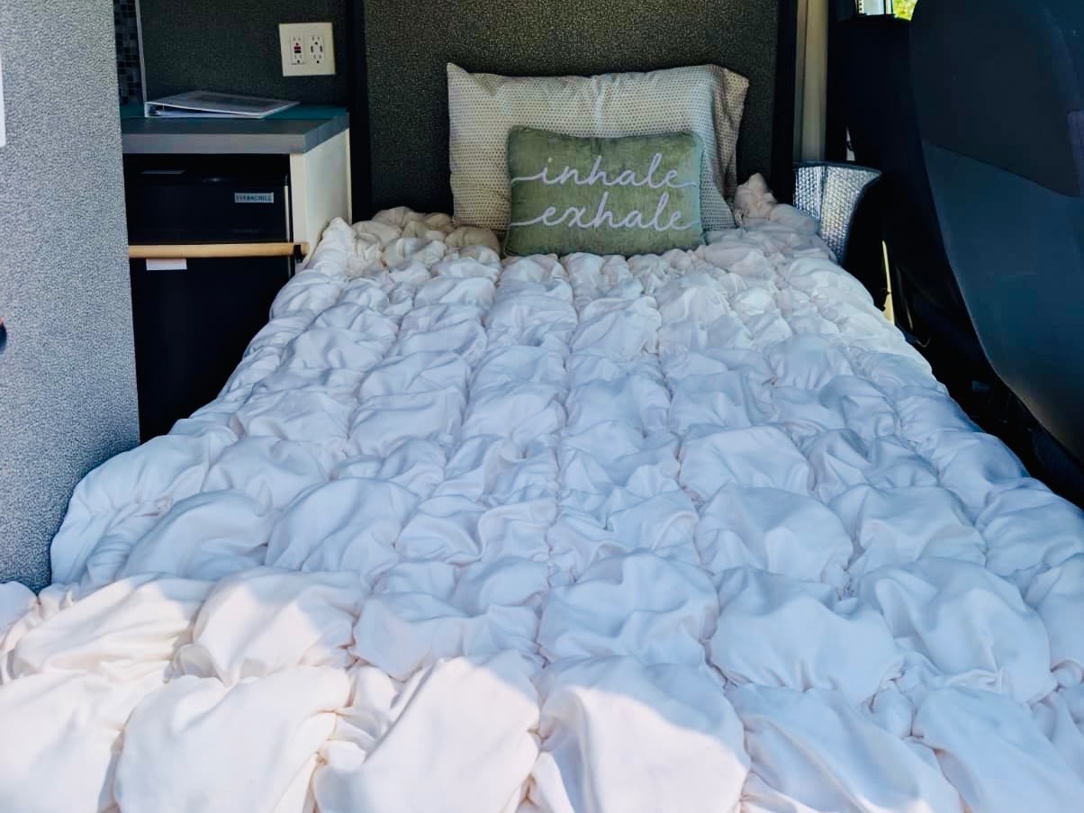 Cozy RV rental bed with unique ruffled comforter, 'inhale exhale' pillow, & compact fridge. Your comfortable camper.. Dodge Ram ProMaster 3500 2018
