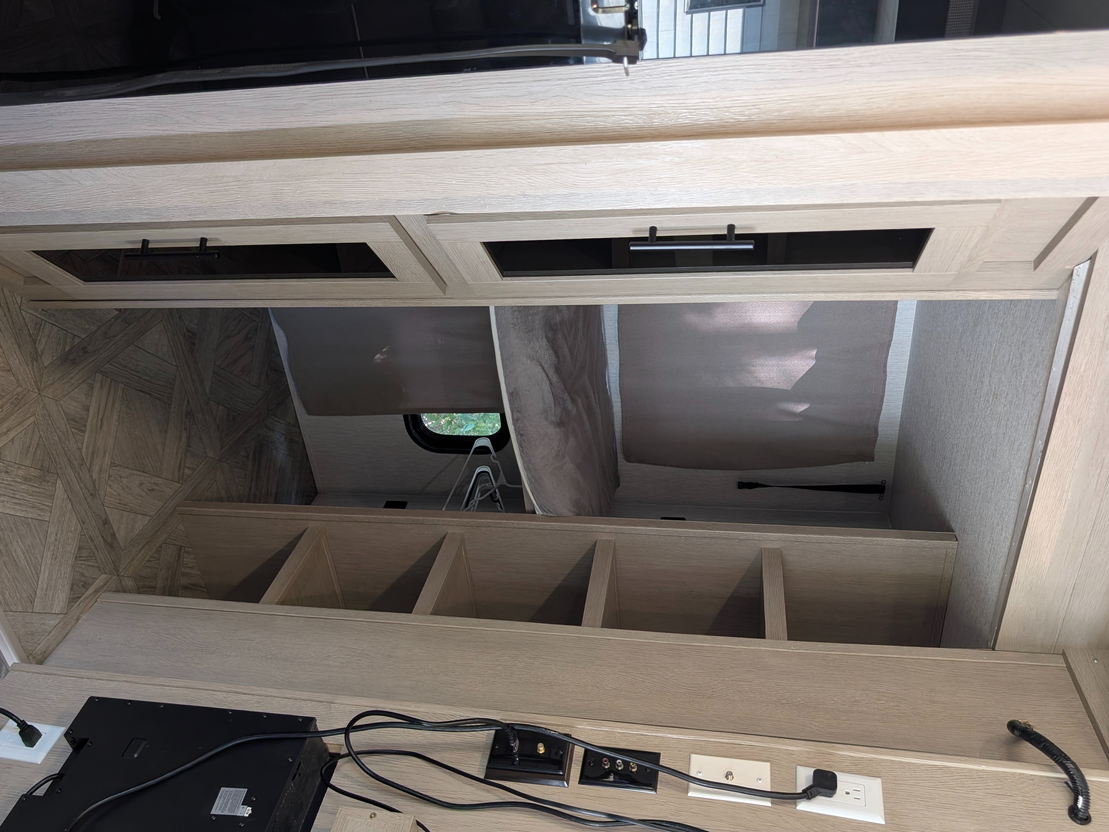 RV rental: Light wood-grain interior with overhead cabinets, open storage cubbies, and a media console with power outlets.. Forest River Salem Cruise Lite Platinum 2024