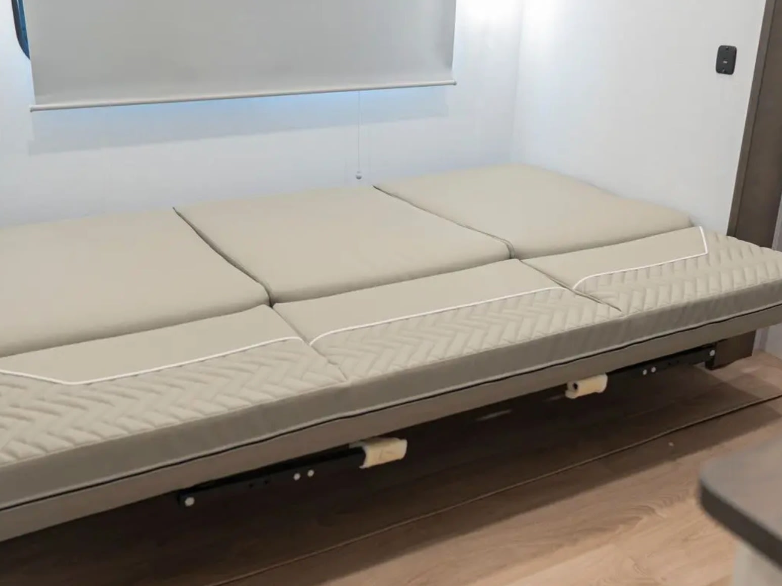 Comfortable, modular bed/seating in this RV rental, featuring versatile quilted beige cushions.. Alliance RV Avenue 2026