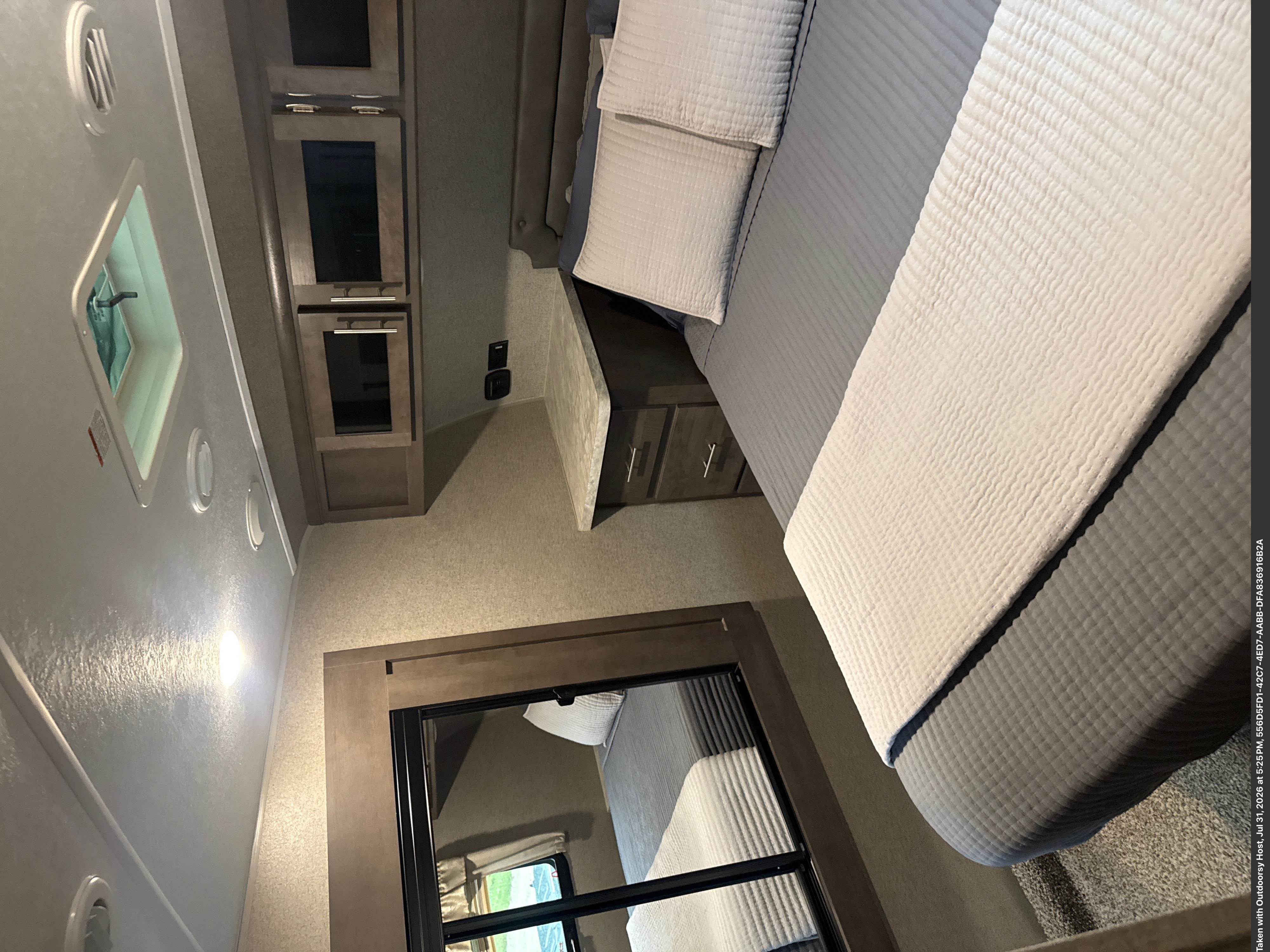 Cozy RV rental bedroom with a comfortable bed, light bedding, overhead storage cabinets, and modern lighting fixtures.. Forest River Flagstaff Super Lite 2020