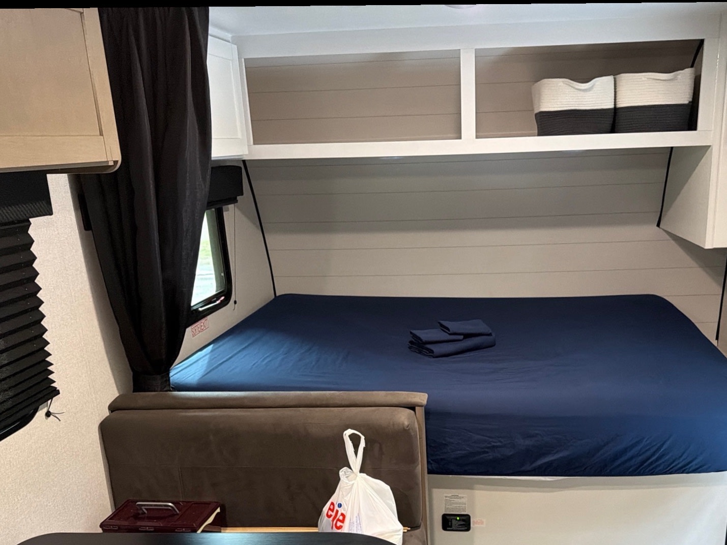 Clean rv rental bedroom with navy bed, shiplap walls, and overhead storage, ready for your adventure.. Jayco Jay Flight SLX 2026