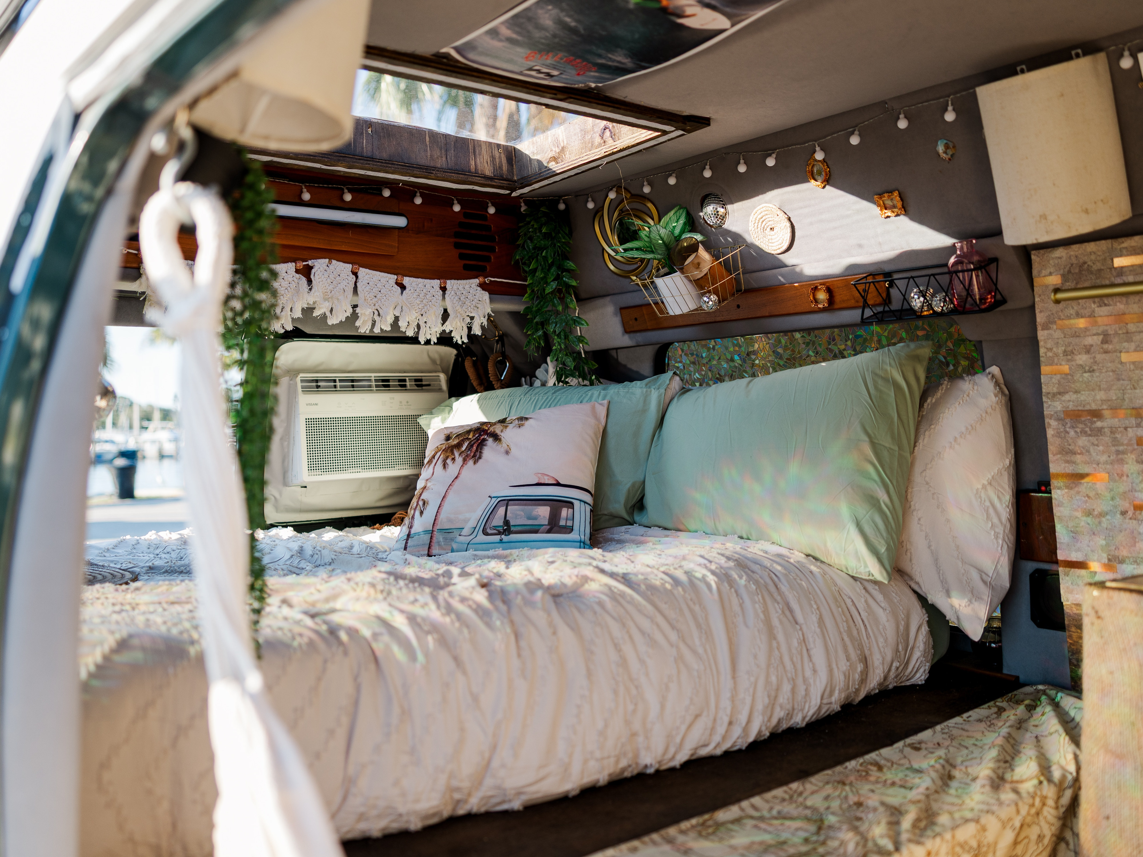 This cozy RV rental features a decorated interior with a comfortable bed, portable AC, and a skylight for travel adventures.. Dodge Ram 1500 2003