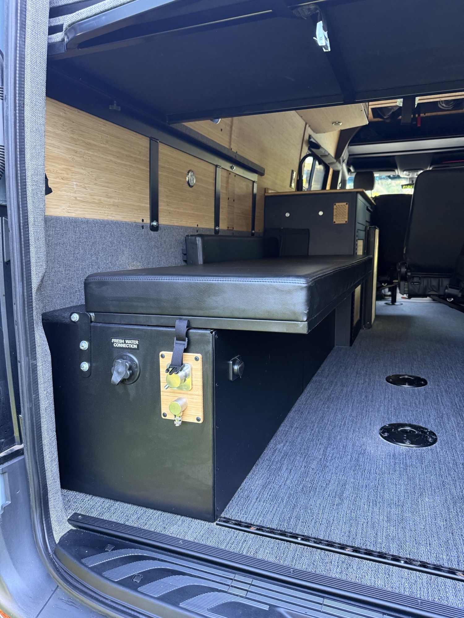 **RV rental** interior: a converted van with a fresh water connection, comfy bench seating, and smart storage solutions.. Vanworks Switchback 2026