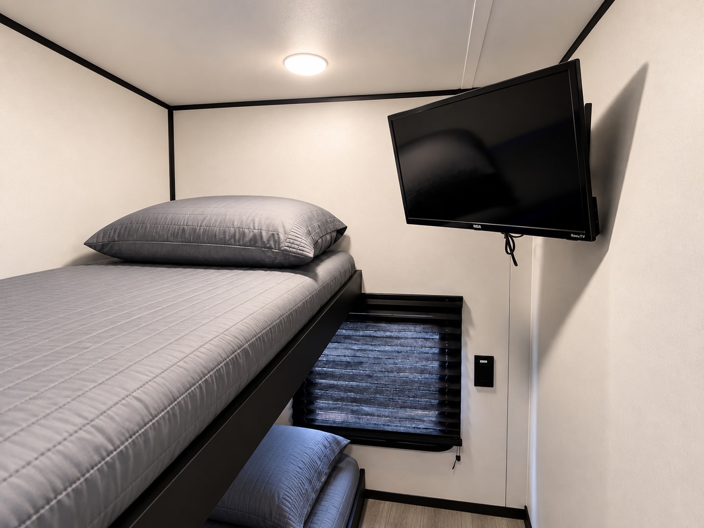 Cozy RV rental bunk beds with a TV & window blinds. A comfortable, compact sleeping area for your camper.. Keystone RV Springdale 2022