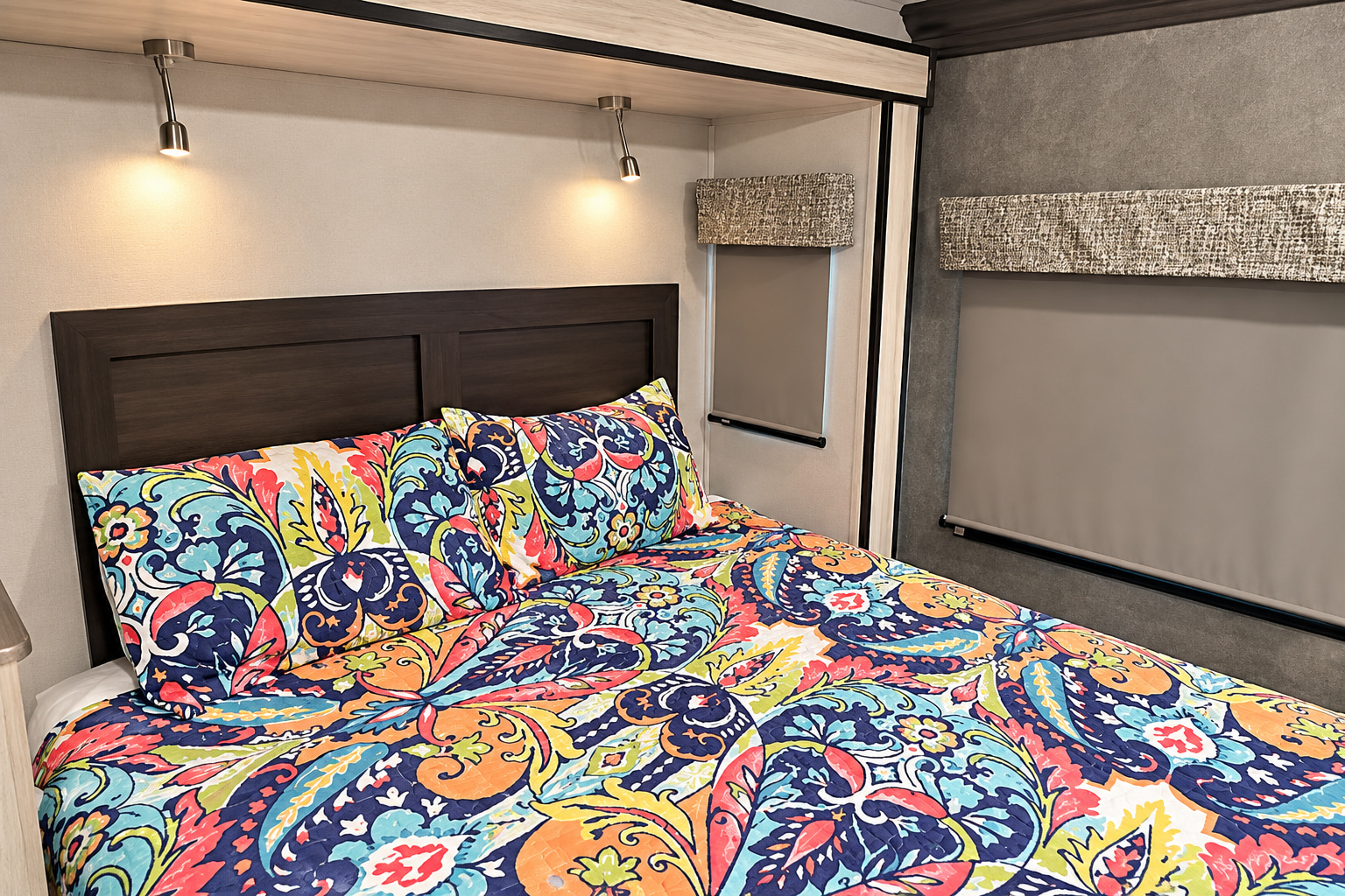 Bright and cozy RV rental bedroom interior, featuring vibrant paisley bedding, reading lights, and roller shades.. Forester Classic 2021