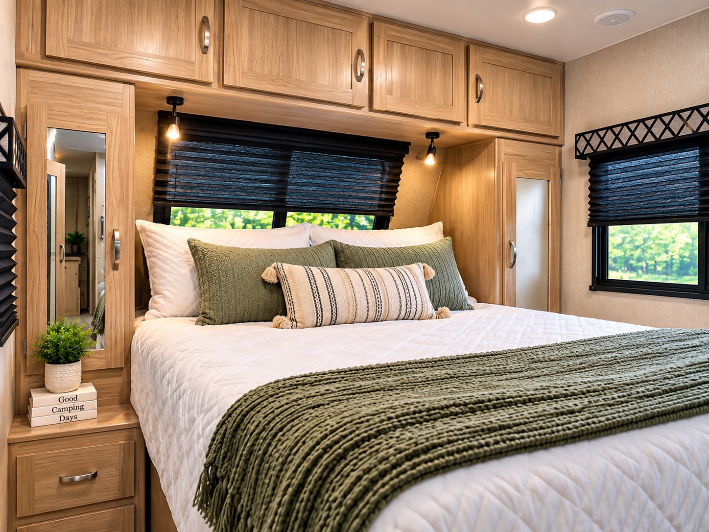This cozy RV rental bedroom offers a comfortable bed, overhead storage, and scenic windows, perfect for restful travels.. Coachmen Freedom Express Ultralite 2021