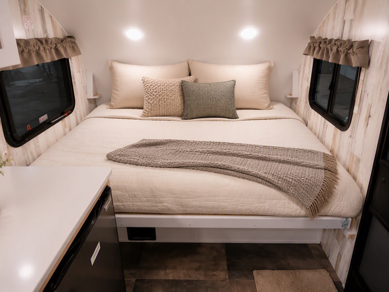 Cozy RV rental bedroom with a comfortable bed, neutral decor, and soft lighting. Ideal for a relaxing camper interior.. Travel Lite Rove Lite 2023