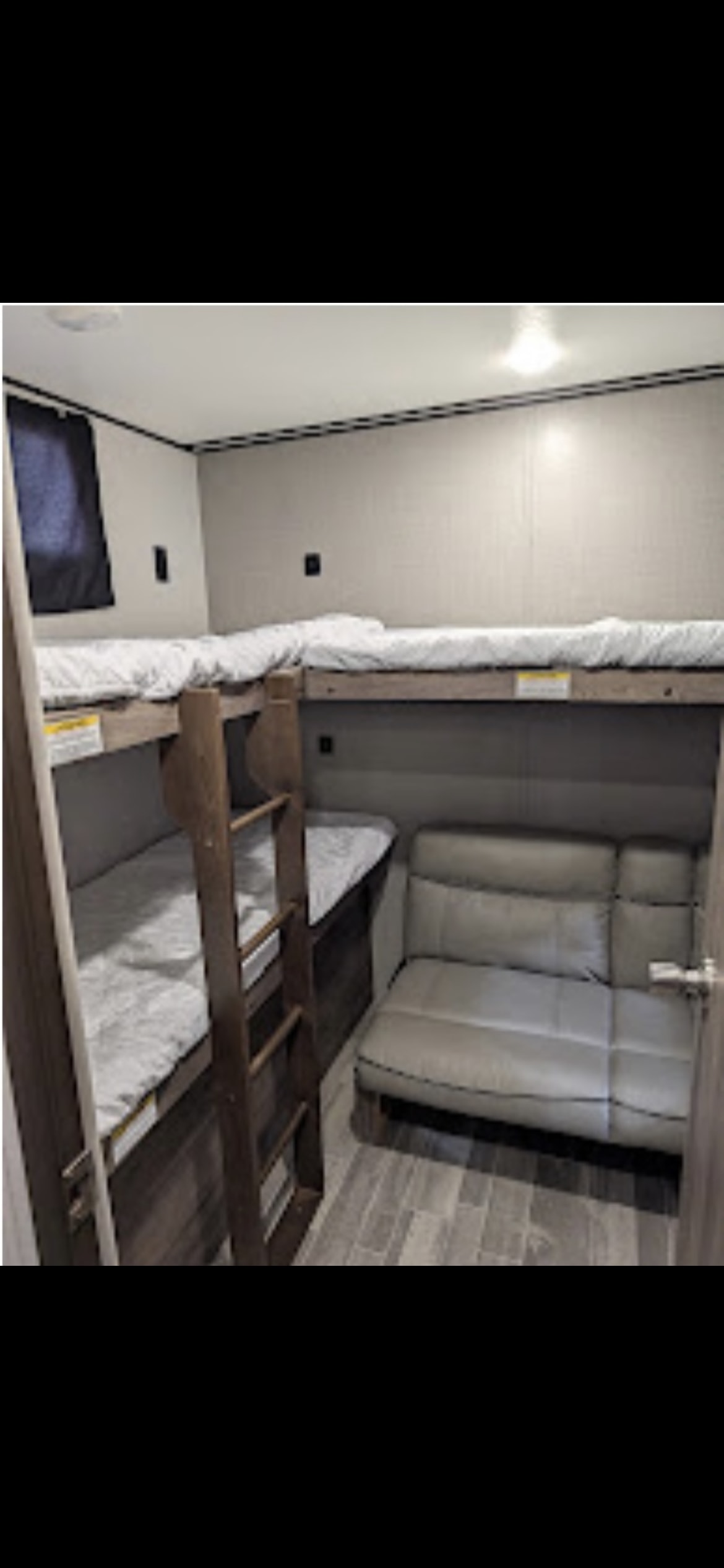 This RV rental bunkhouse features cozy bunk beds with a ladder and a comfortable sleeper sofa.. Cross Roads Zinger 2021