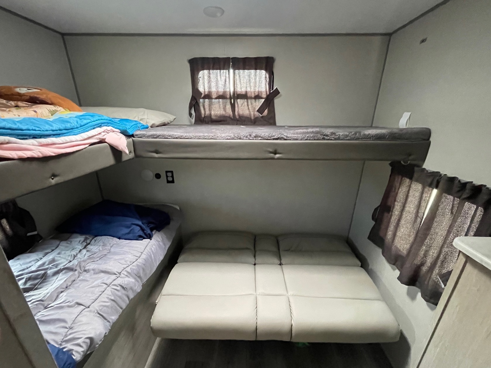 RV rental interior showcasing two bunks and a folded-out convertible bed for ample sleeping space.. Coachmen Catalina Legacy Edition 2024