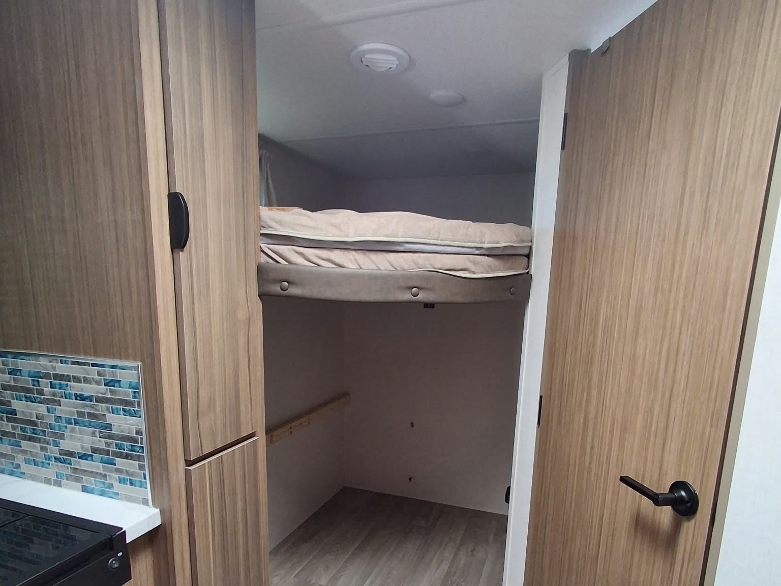 RV rental: This travel trailer features bunk beds, wood cabinetry, and a compact kitchen area with a blue tiled backsplash.. Forest River Salem FSX 2026
