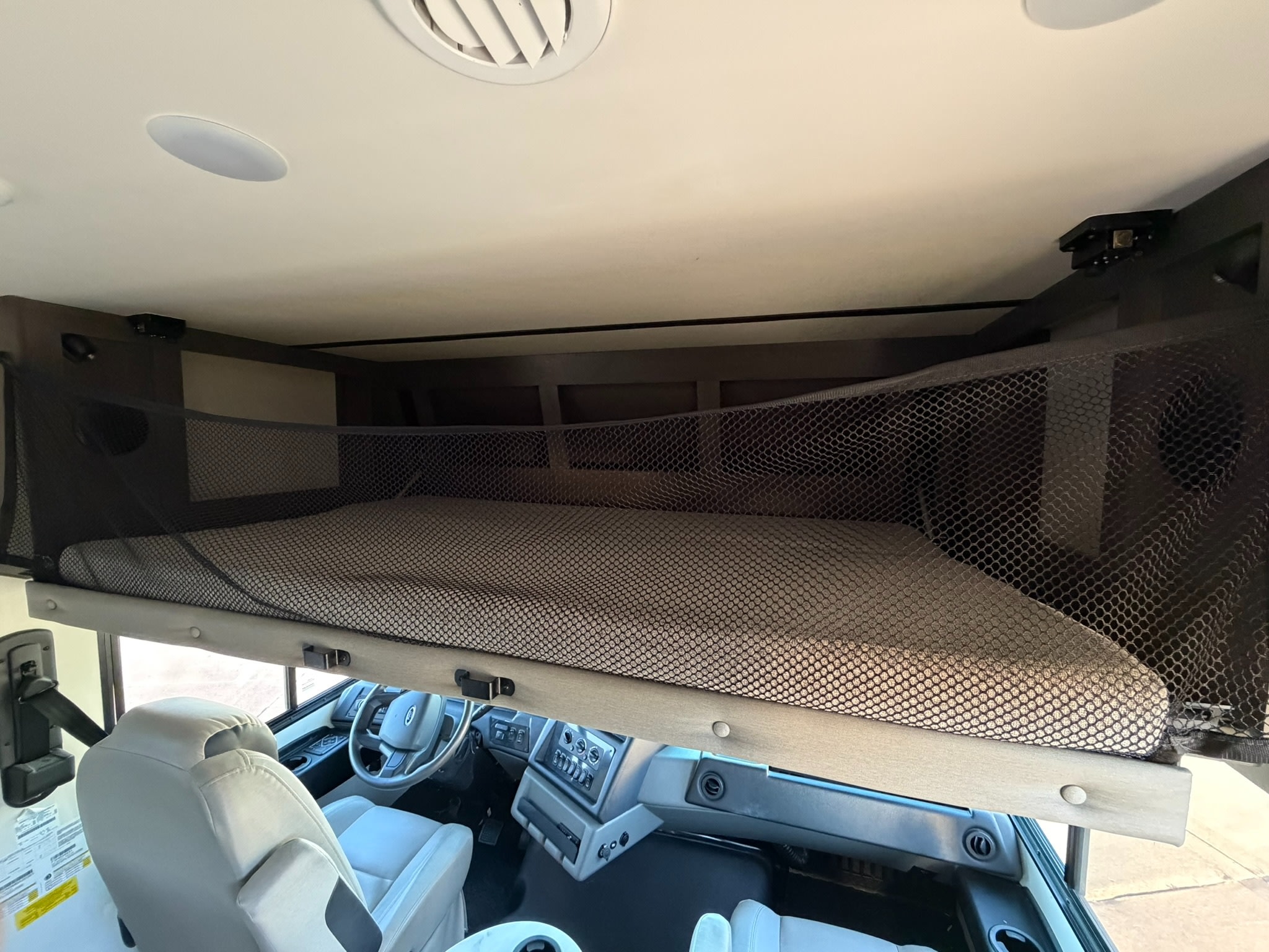 This RV rental features a comfortable overhead bunk with a safety net, positioned above the driver's cabin for extra sleeping space.. FR3 FR3 Motorhome 2022