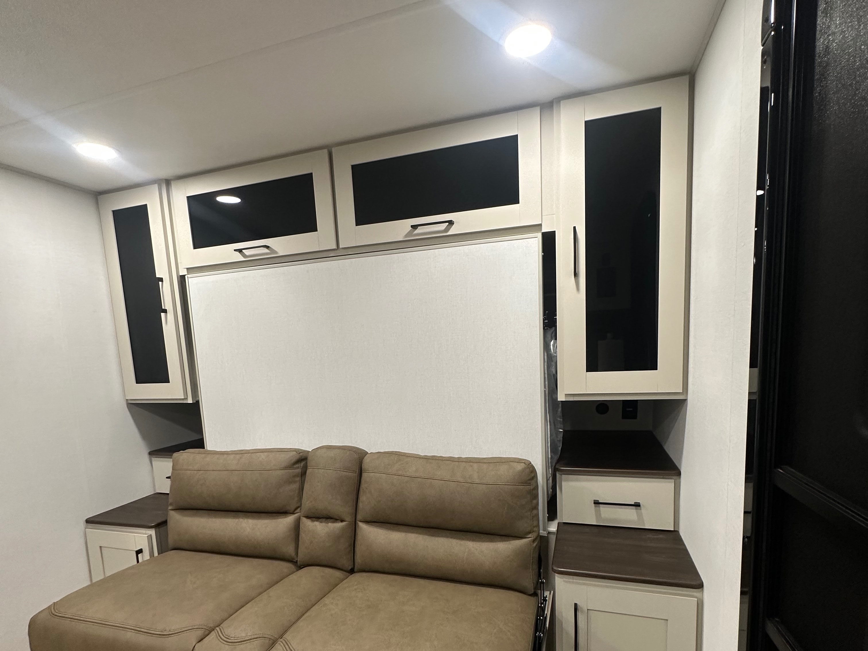 RV rental: Modern interior features a comfortable sofa, convertible bed, and overhead storage cabinets.. Alliance Delta BH181 2027