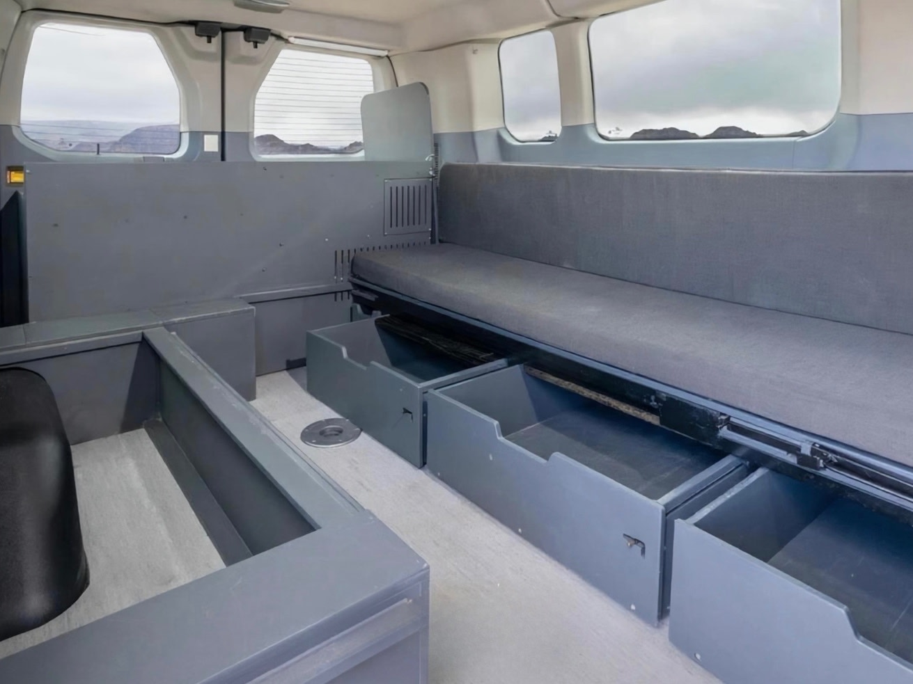Functional rv rental interior: built-in seating, pull-out drawers for storage, and a scenic view out the windows.. Ford Transit 2016