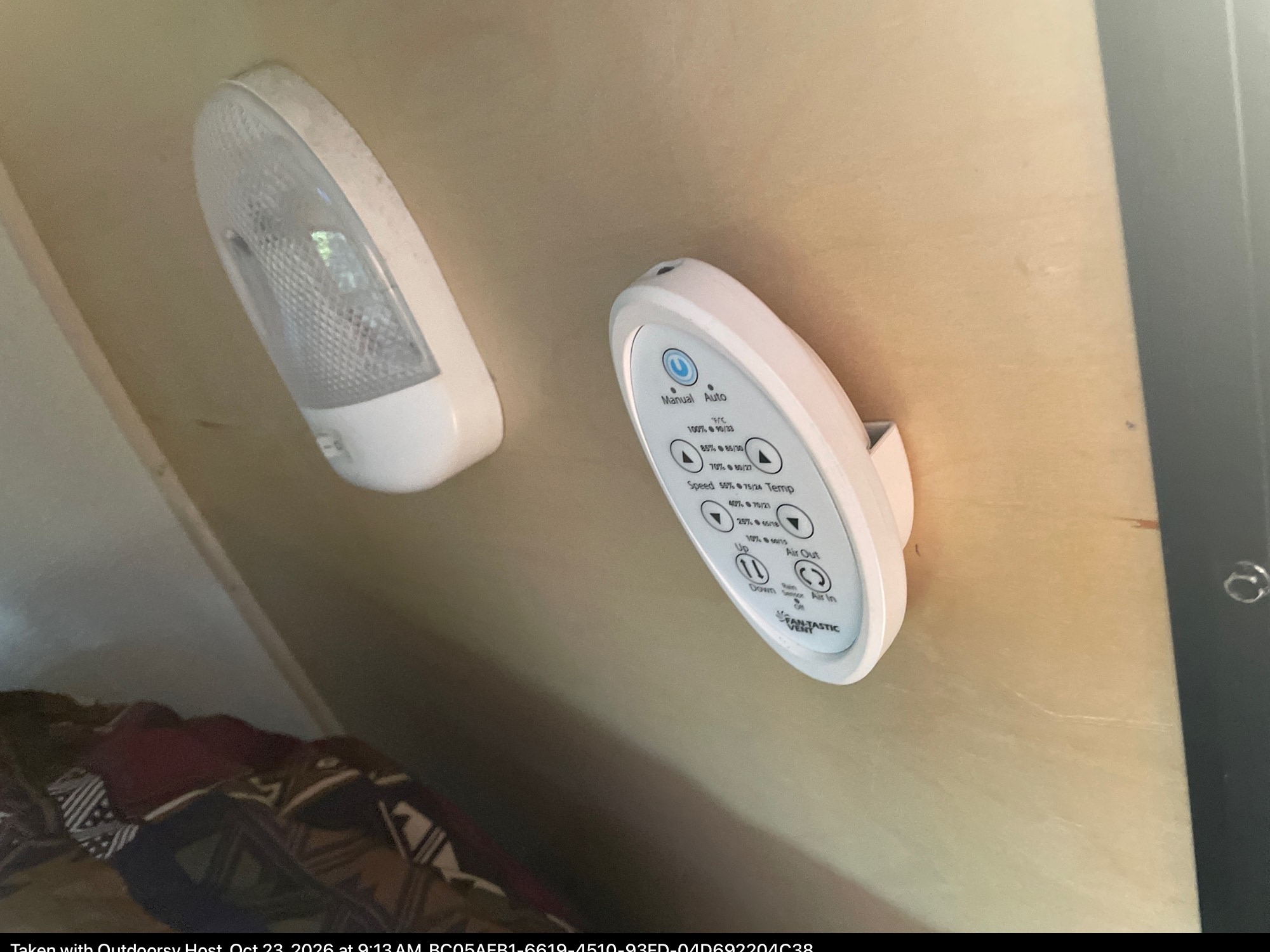 RV rental interior with a Fantastic Vent climate control panel and an overhead light on a wood-paneled wall.. hand built teardrop 2016