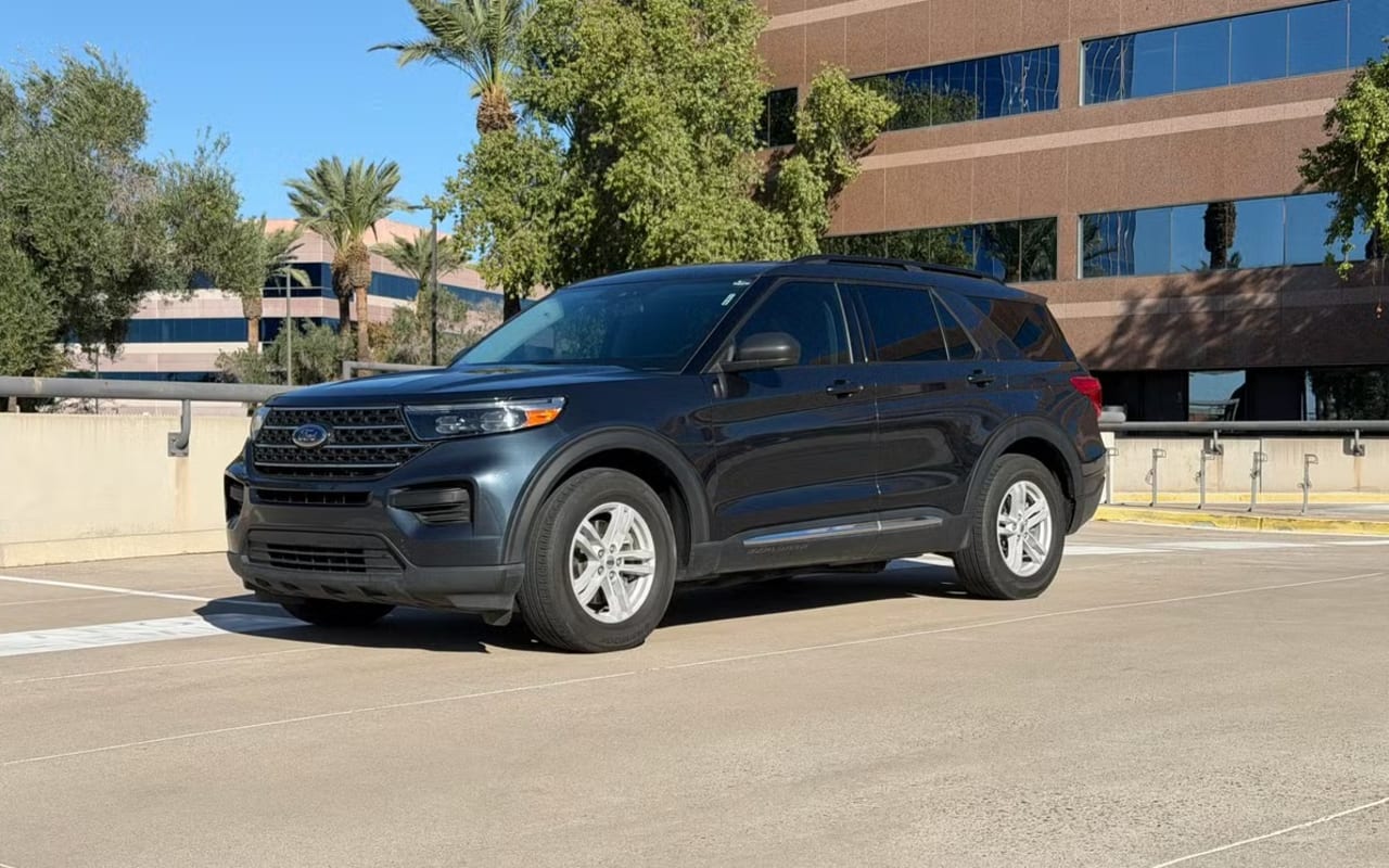Dark gray Ford Explorer SUV parked in a sunny lot, ready for your next car rental adventure