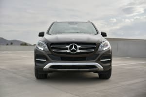 Front view of a brown Mercedes-Benz SUV, a rental option for travel