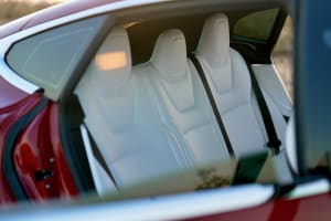 Bright white rear seats of a modern red car, offering premium comfort for journeys, perfect with your next RV rental