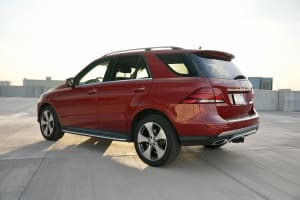 Red Mercedes-Benz GLE 350 SUV on a sunny rooftop