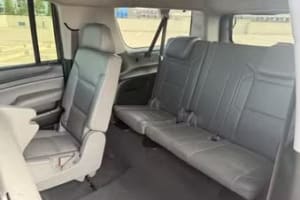 Car rental: Spacious SUV interior with grey leather second and third-row passenger seats