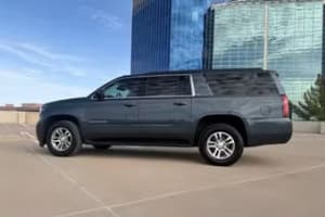 Experience comfort with this dark gray extended SUV rental