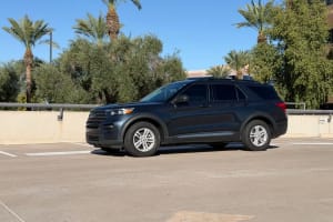 Dark SUV parked in a sunny lot, ready for adventure