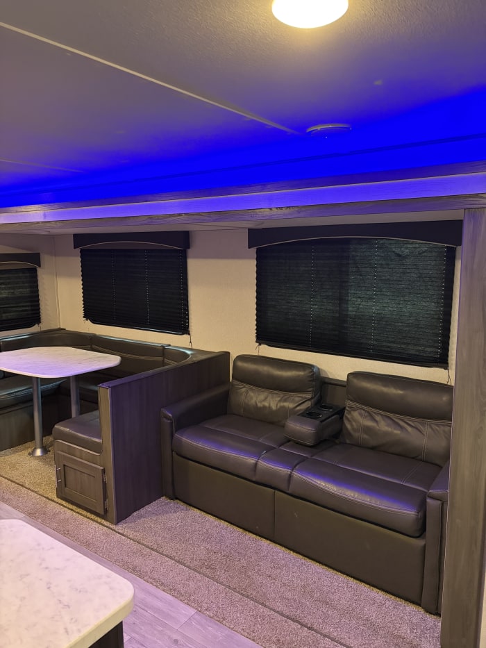 U-shaped dinette and sofa inside The Shasta