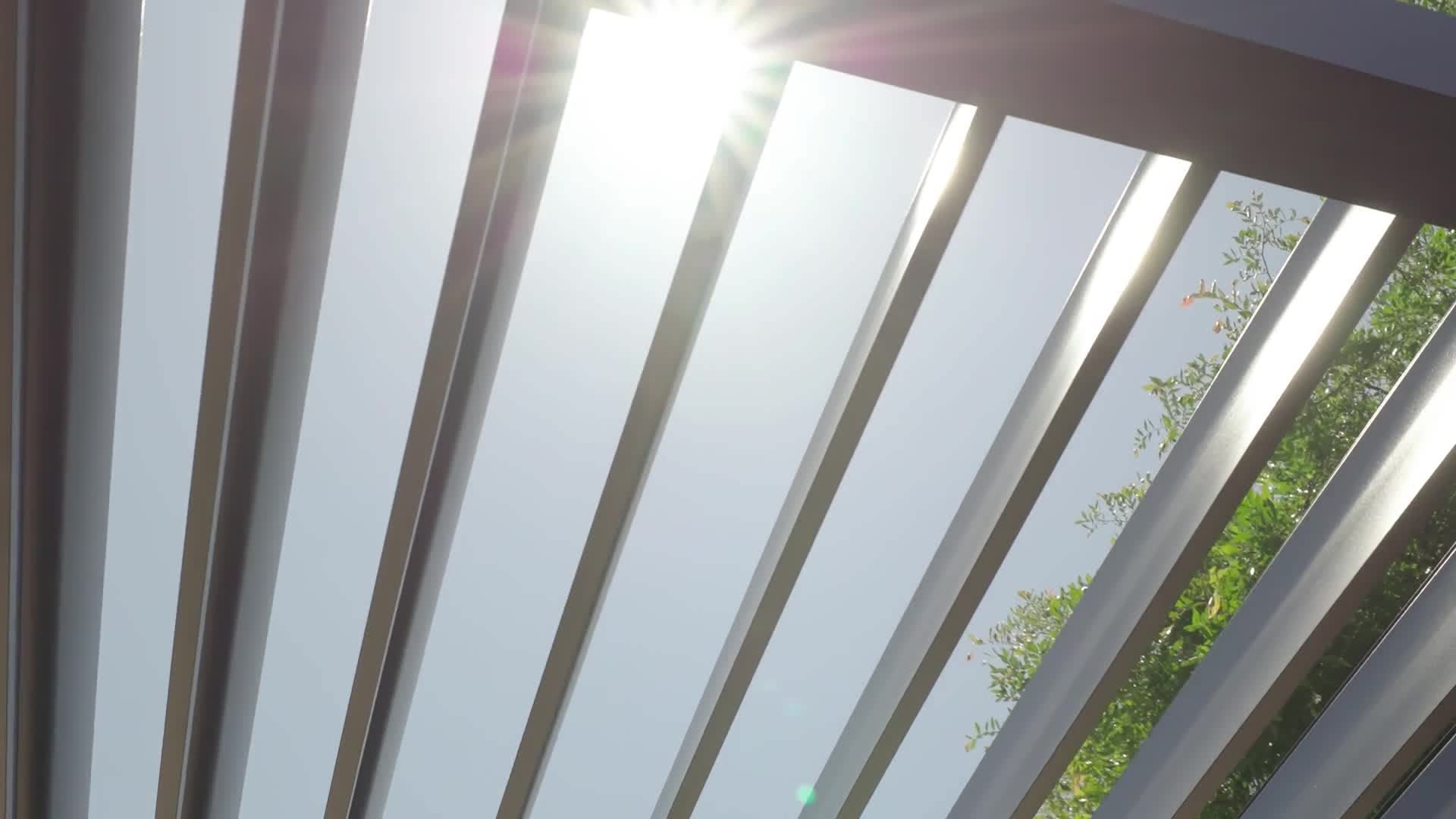 Sunlight raking through the adjustable louver blades of an Outer Spaces pavilion