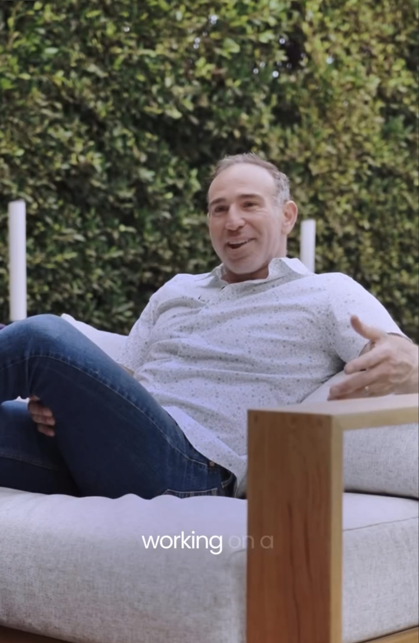 Ben talking while seated in an outdoor lounge chair