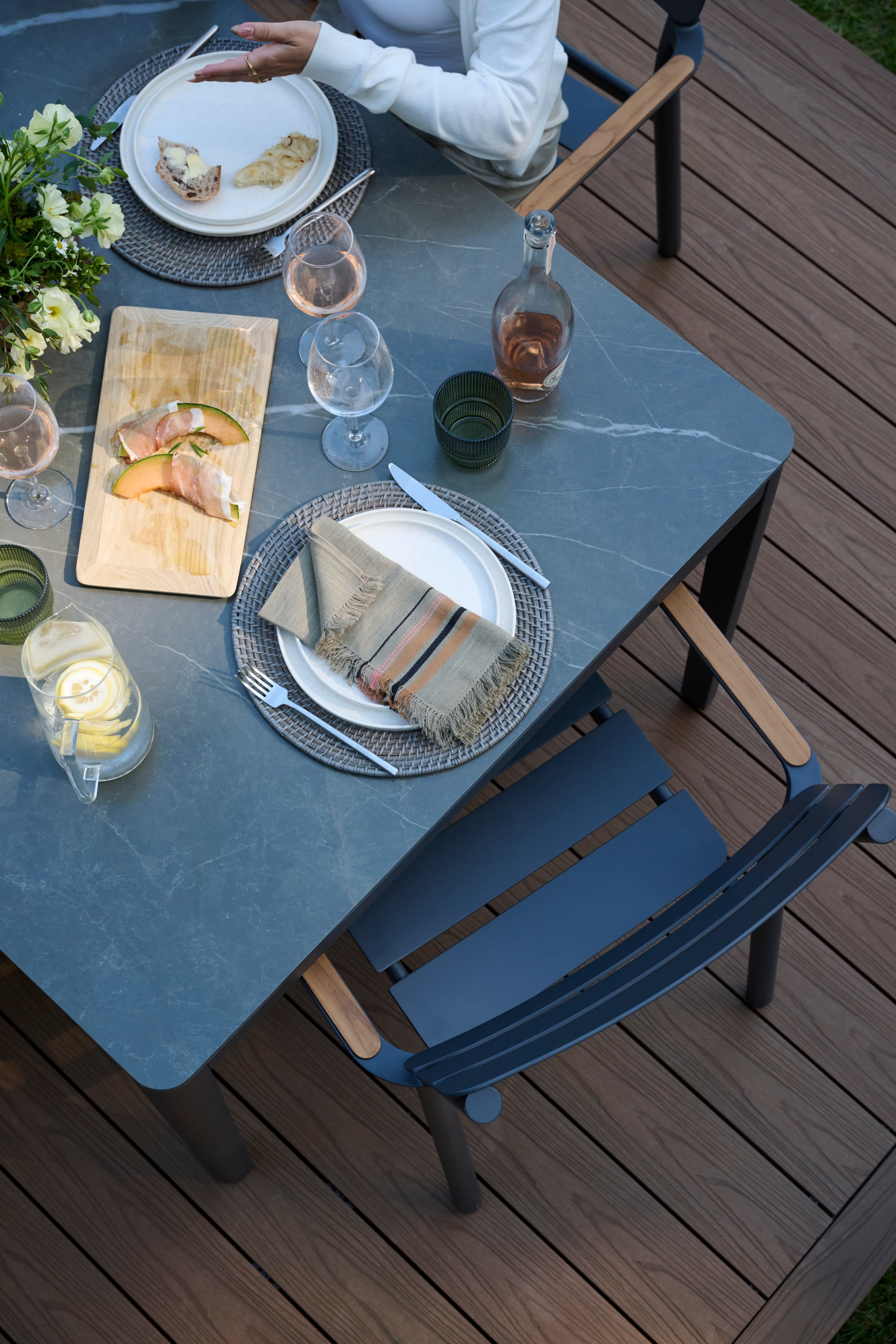 An outdoor dining table set for a meal on a Haven deck