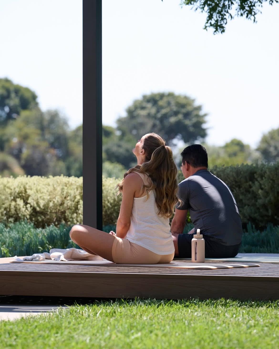 A couple sitting together and relaxing on a Haven deck