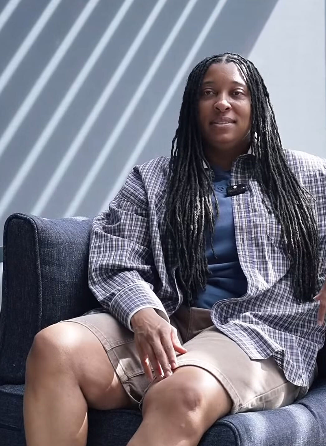 Mercedes talking while seated on an outdoor sofa