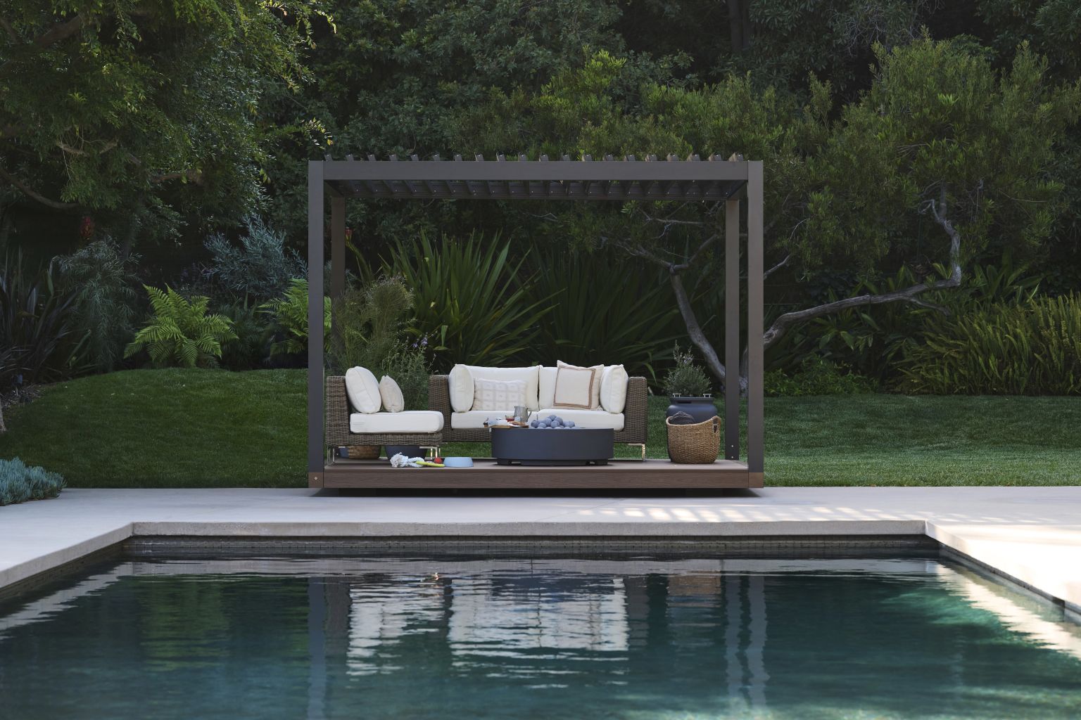 Lounge seating beneath an Outer Spaces pergola