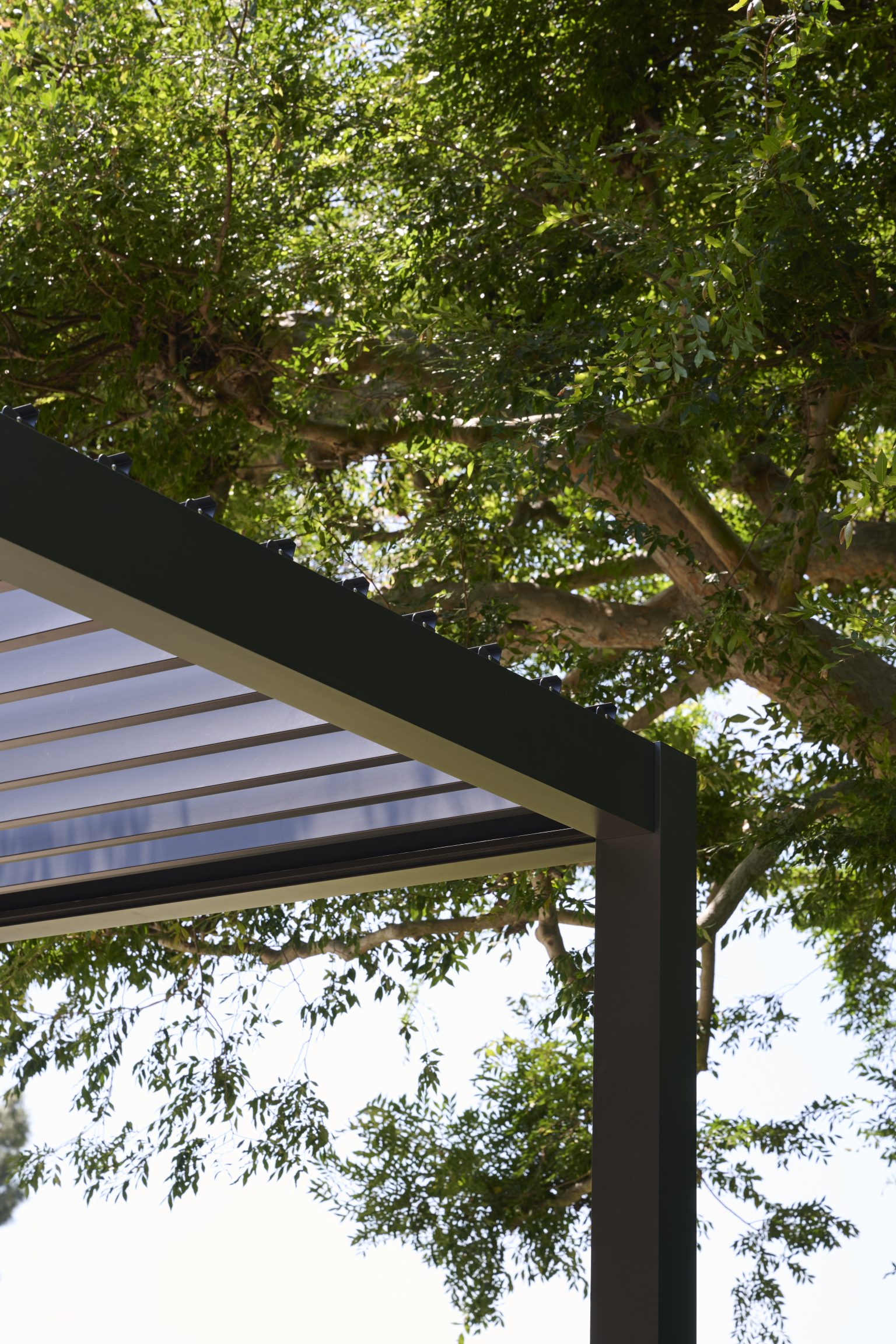 Outer Spaces pergola and deck system in a backyard setting