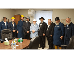 Picture of David Elliot owners with Rabbi Klarberg.