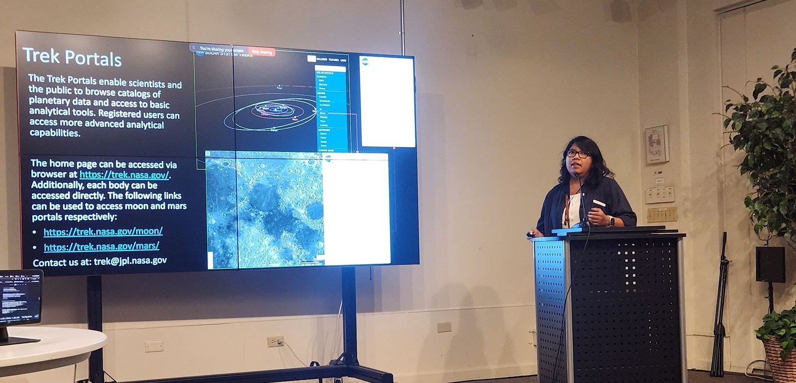 Natalie Gallegos giving a live demonstration of NASA's Moon Trek route-planning platform during the AI/ML session