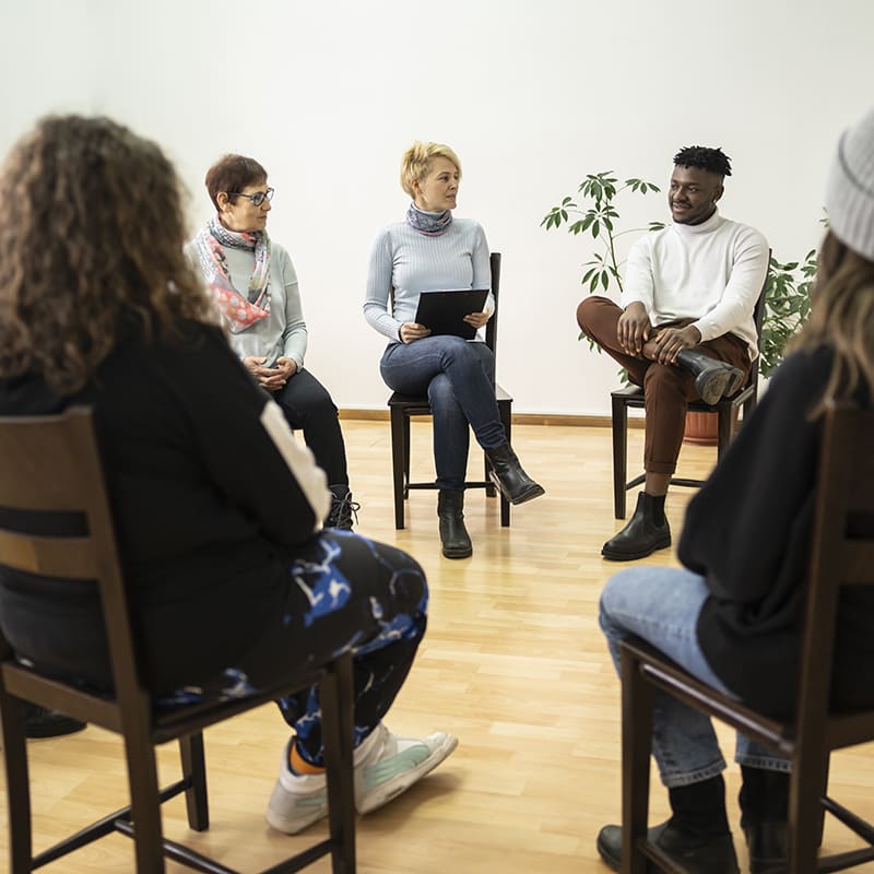 Group therapy support meeting talking about their mental health