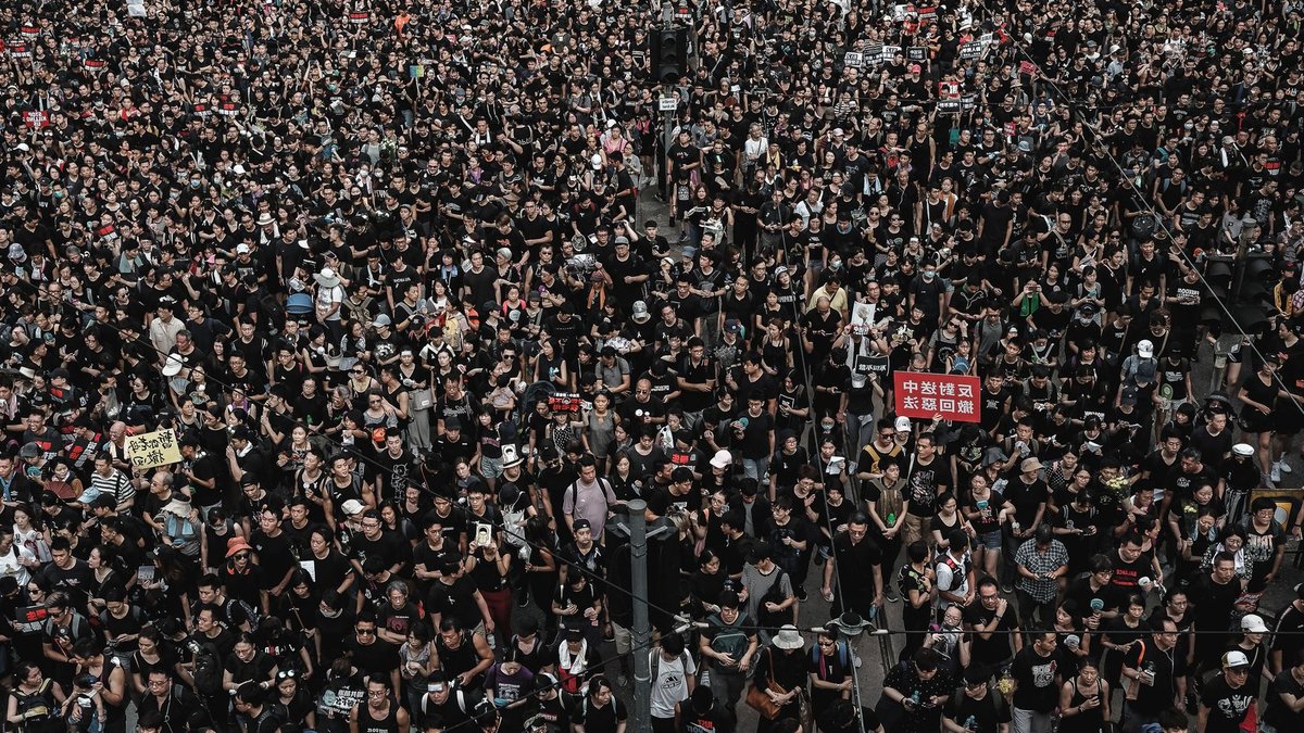 Aerial view of a large crowd demonstration in Hong Kong, demanding justice.