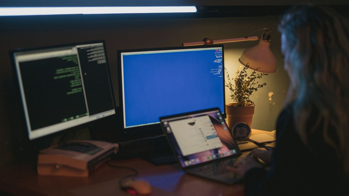 Liquid C2 expands KnowBe4 services across Africa Woman using multiple screens for cybersecurity tasks in a cozy home office.