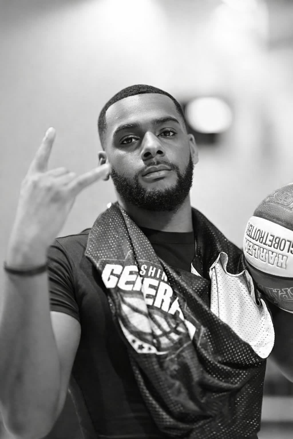 Black and white portrait of Tauris Watson holding a basketball