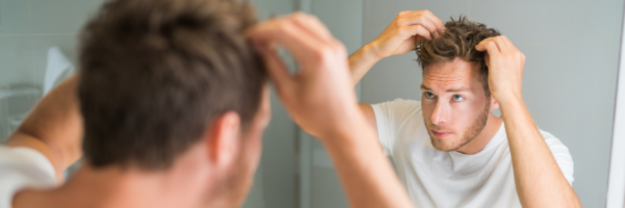 Guy checking his hair