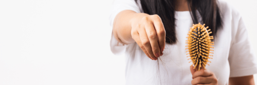 Woman holding up shredded hair