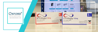 White logo in an aqua box over a white background on the left third of the image. The two remaining thirds of the image on the right show two clear white boxes of piriligy in front of a out-of-focus laptop.