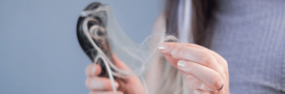 woman noticing early signs of hair loss