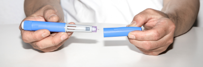 man holding weight loss pen