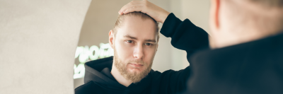 man checking for hair loss after steroids