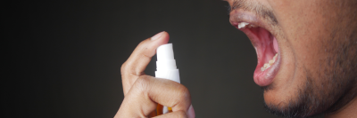 man spraying erectile dysfunction spray into mouth