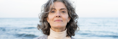 Older woman with grey hair at the beach